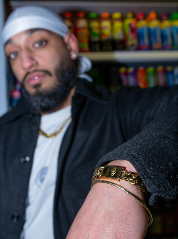 Man wearing gold cuban link bracelet in a shop